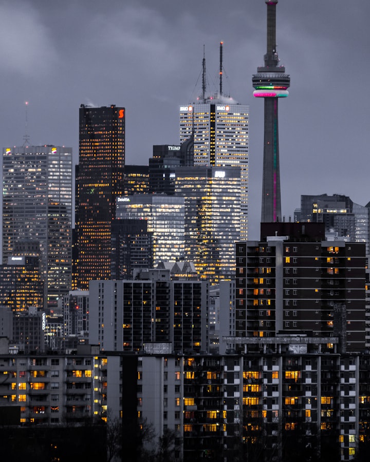 The CN Tower above downtown Toronto at dusk.