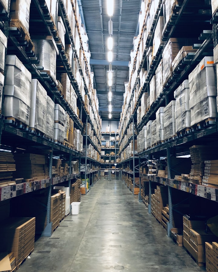 A warehouse aisle stacked with palletised goods ready for export.